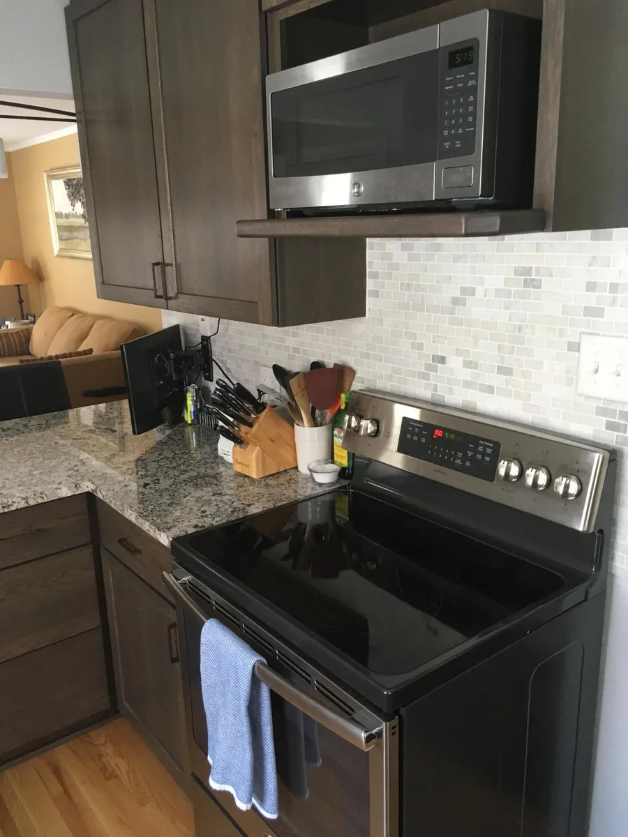 Range, microwave, backsplash in kitchen - 4134 Alabama Ave S