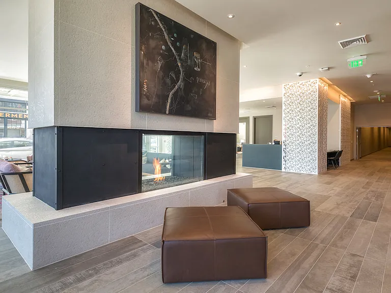 Spacious lobby with fireplace and modern furnishings for relaxing moments.