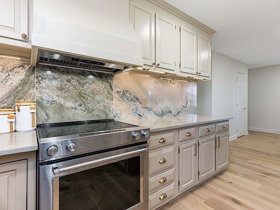 Luxury updated kitchen with granite countertops&backsplash, stainless steel appliances and recess lighting