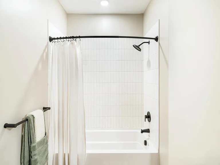 Subway tile surrounds and matte black fixtures give the bathroom a fresh, modern feel.