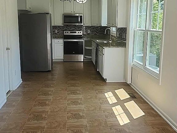 Kitchen with its Whirlpool and Samsung brand appliances.