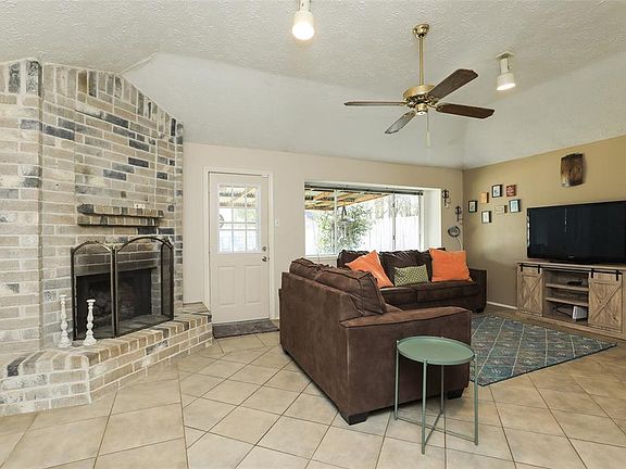 Notice the corner brick fireplace, windows which overlook back deck and door/storm door that leads to your back yard