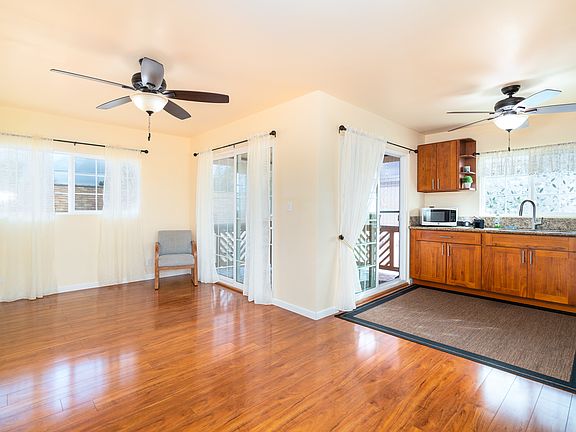 Living room and kitchen with entrance to lanai. Very breezy and cool. Energy efficient and quiet fans in every room.