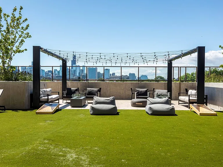 Unwind in the rooftop grassy beanbag area, the perfect spot to relax and enjoy the view in a casual, comfortable setting.