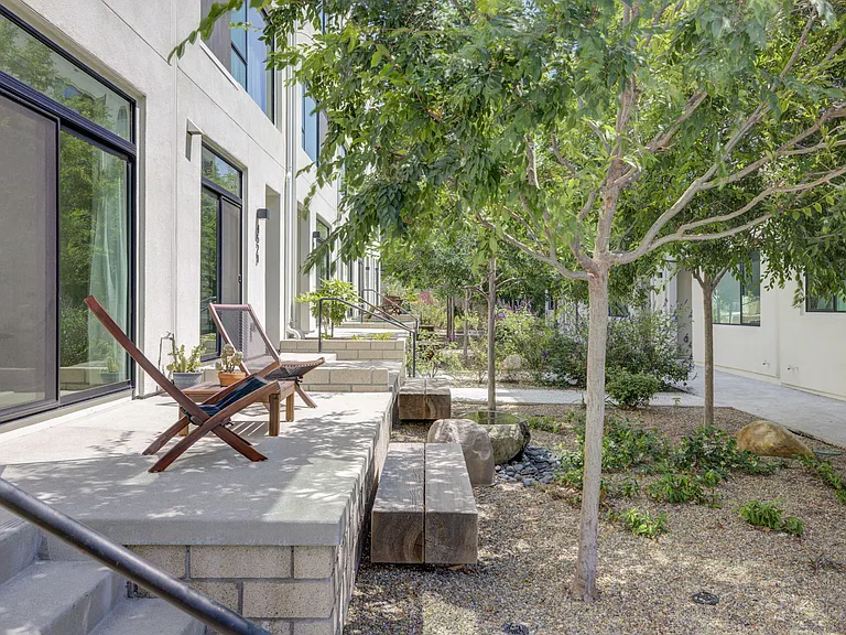 Just steps from the front entrance, enjoy a beautifully landscaped community green space featuring mature trees, lush plantings, and seating areas_often referred to as the community's "Central Park."