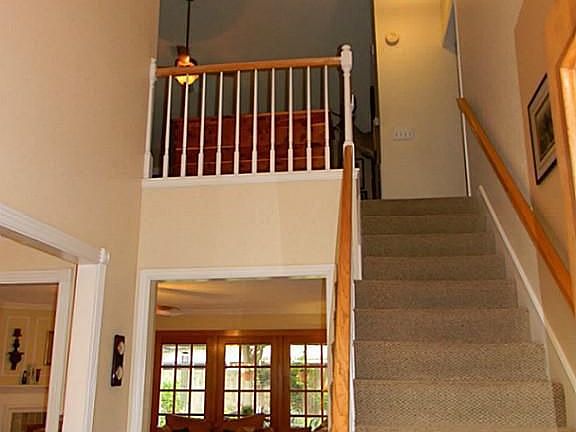 View of staircase from entry. Light fixtures have been replaced.