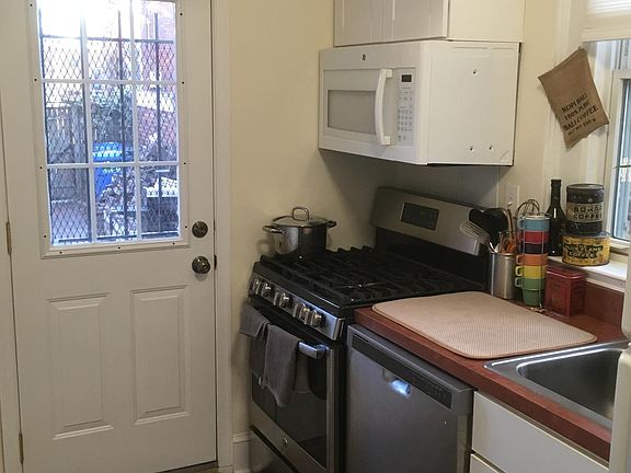 other side of kitchen with rear entrance to backyard