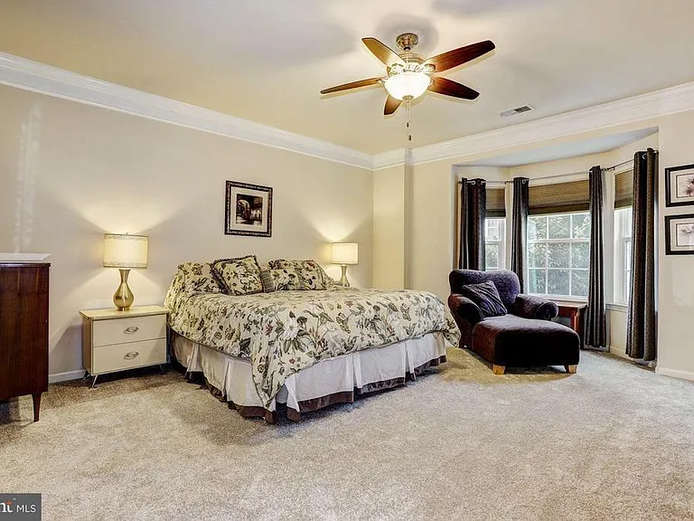 Master suite with dual walk-in closets, bay window and en suite master bathroom.