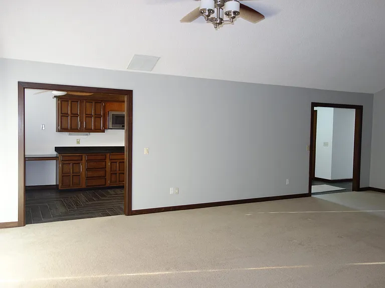 another living room view. access to kitchen on left and entry on right.