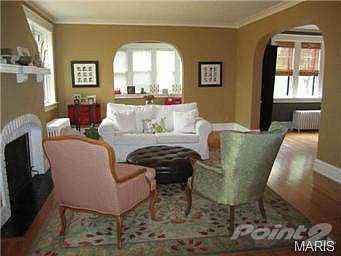 Living room with view of sunroom and dining room.