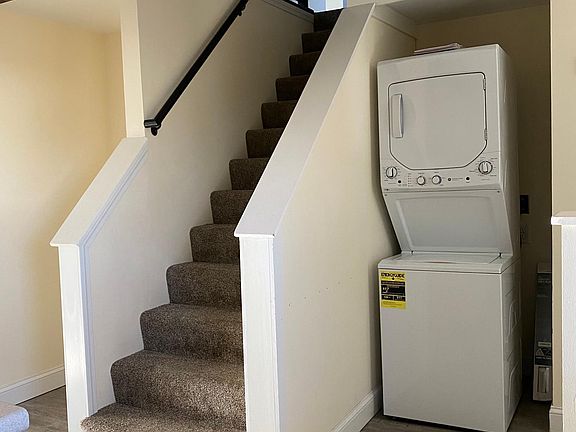 view of stairs and entry / washer/dryer from the kitchen