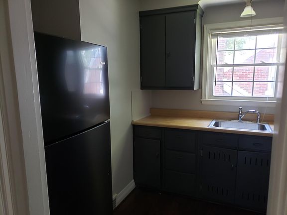 Kitchen with black stainless refrigerator and stove.