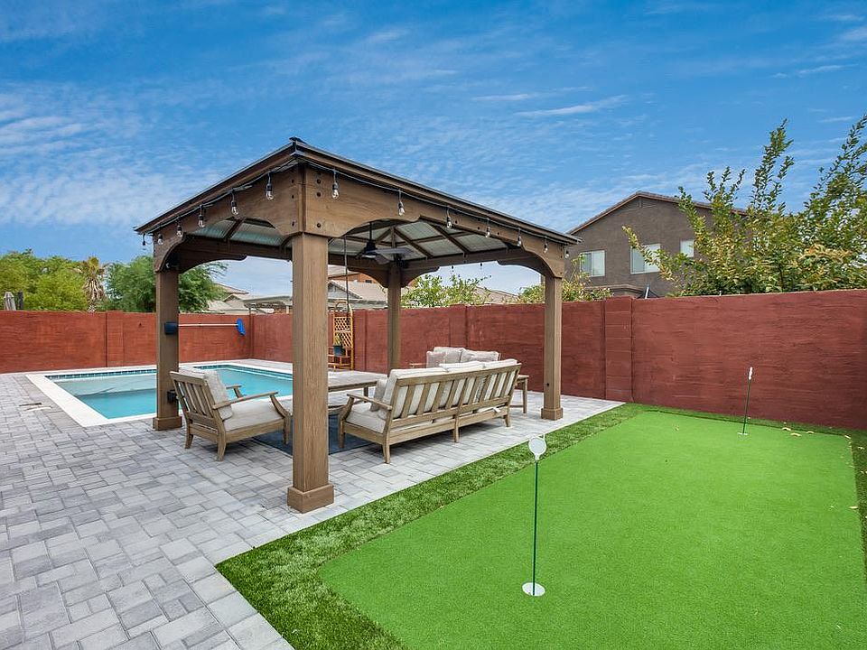 Pergola with seating and putting green