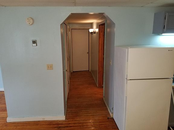 Hallway leading to bathroom (on right) and 2 bedrooms. Very large (lit) pantry/linen closet on left.
