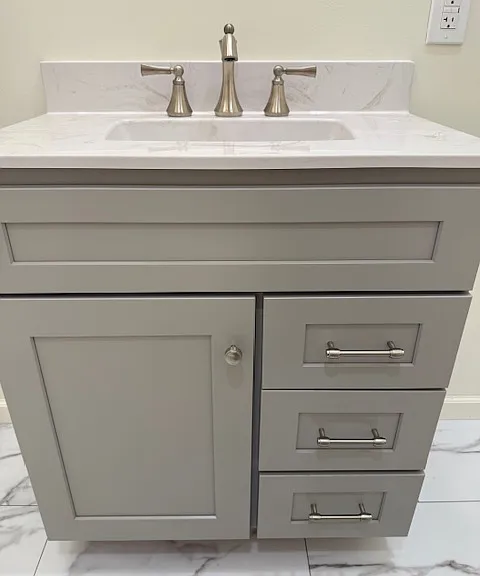 Brushed nickel Moen fixtures. Soft close drawers, offering under cabinet storage.
