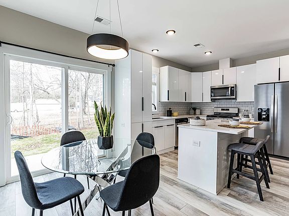 Open floor plan with eat-in area plus a quartz counter top island