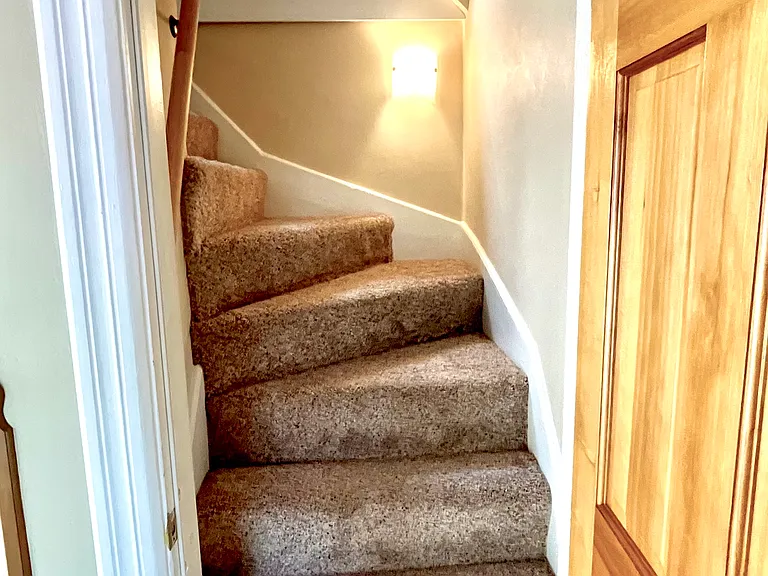 Stairs to finished attic bedroom or living space.