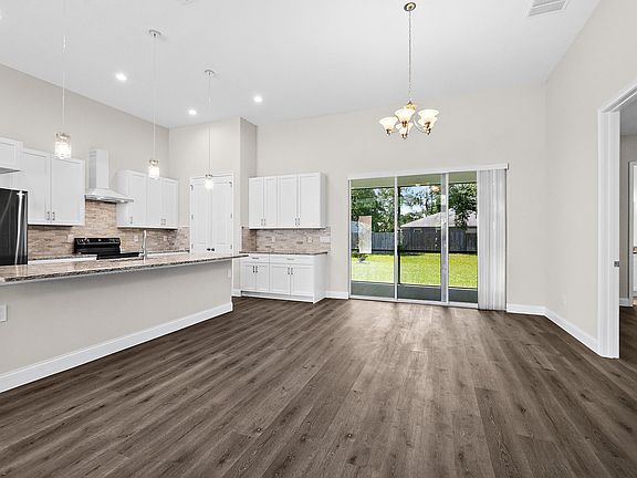 Dining room with kitchen area.