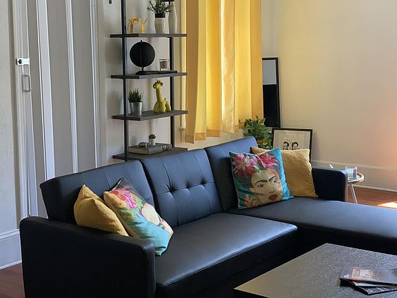 living room and accordion door to second bath and in unit laundry