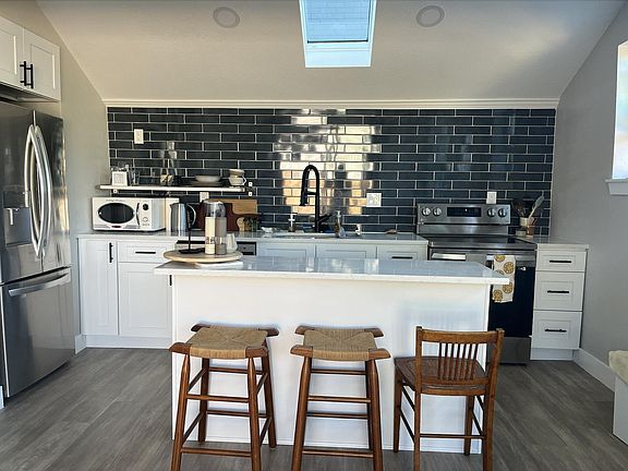 beautiful skylight window, open kitchen, makes this a great social spot