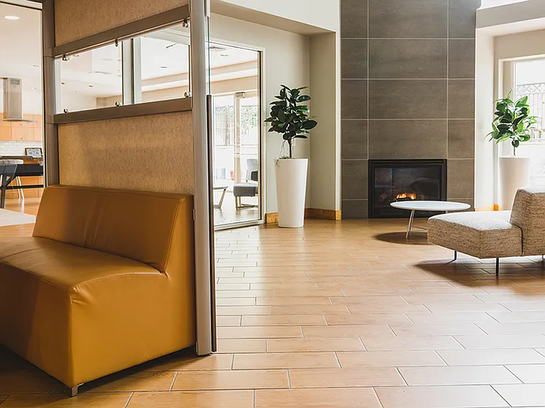 Brightly lit clubroom with ample seating for work or play
