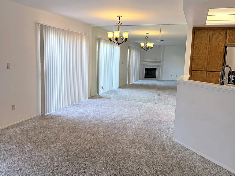 dining off kitchen; mirrored dining room wall adds depth to room