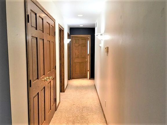 Hallway leading to 3 bedrooms.