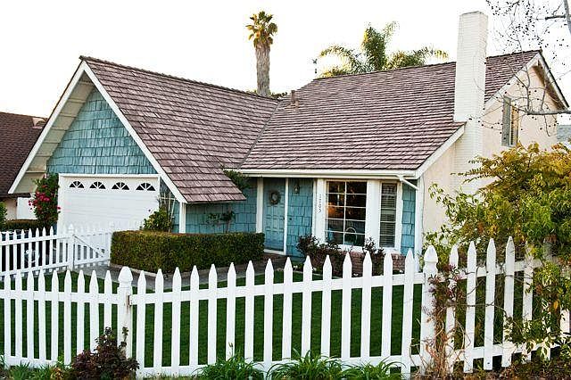 September 2025, house painted and new picket fence.