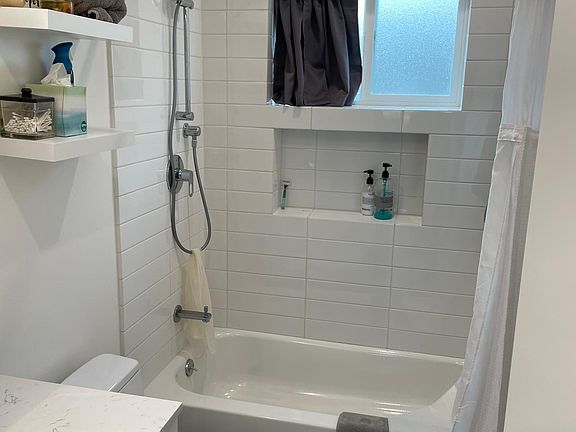 Hall bathroom features a bathtub and built in niche.