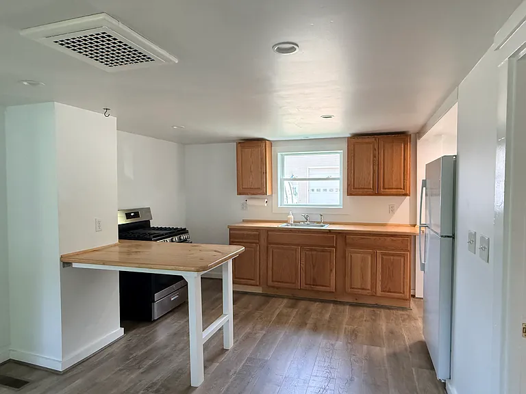 Kitchen. Plenty of room for a large pantry cabinet or shelf next to the stove.