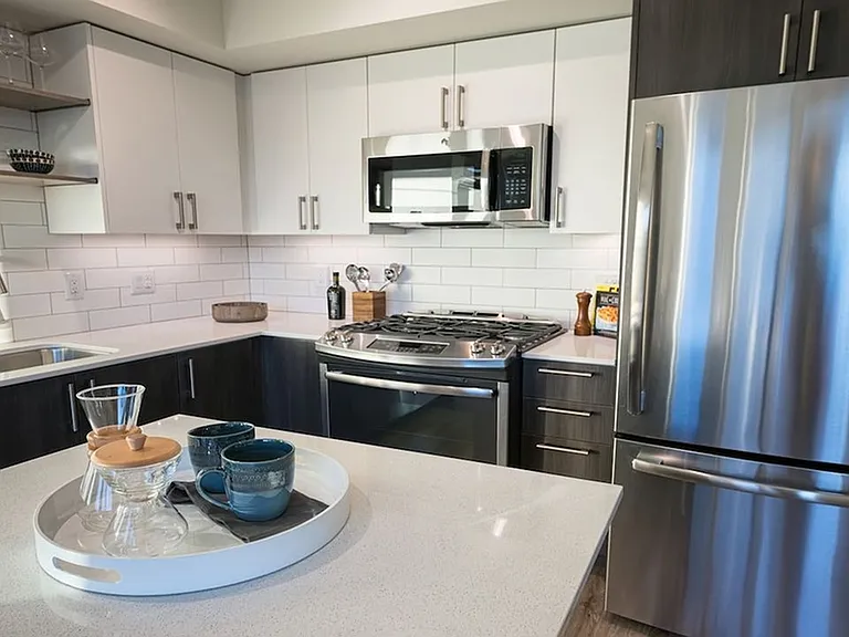 Our kitchens feature high-end finishes including stainless steel appliances and quartz countertops