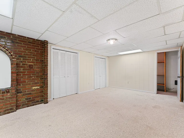 Lower level den or bedroom has lines of closets!