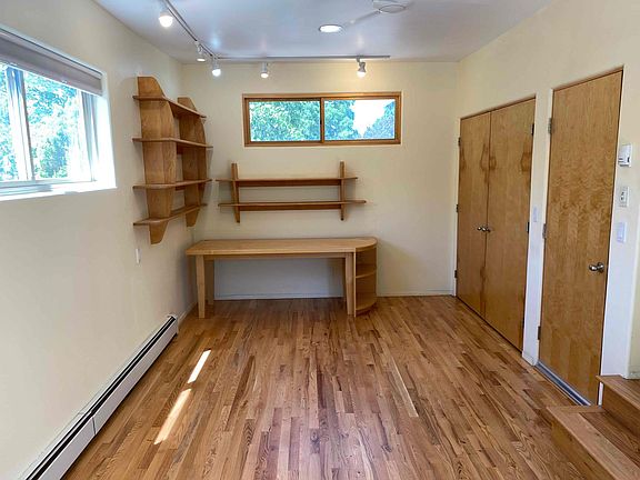 Converted garage has closets leading to washer / dryer and on-demand hot water heater.