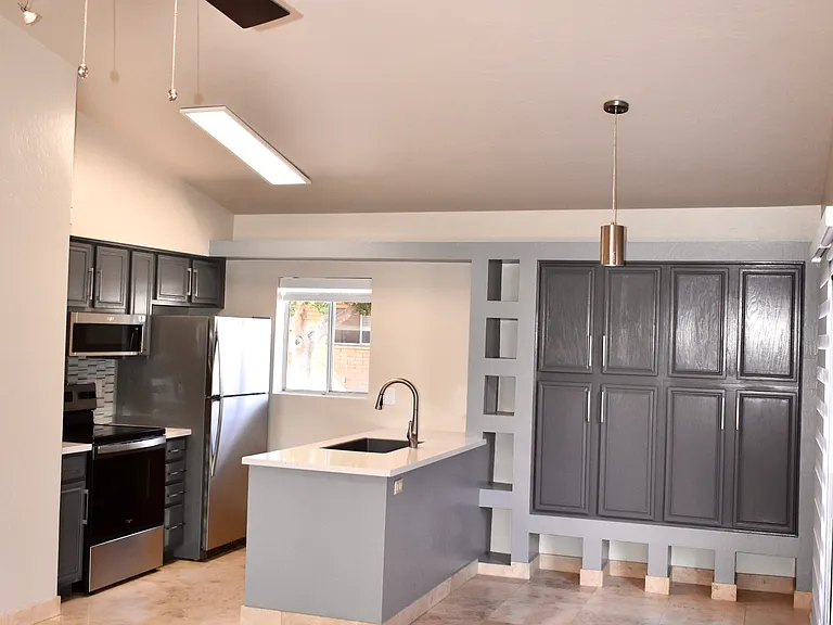 View of the Kitchen from the Living Room - Modern ceiling fan and dimmable cable lights
