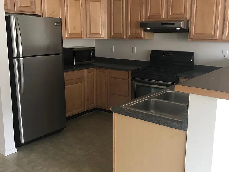 Stainless steel refrigerator w microwave. Double stainless sink w garbage disposal. Plenty of wood paneled cabinets.