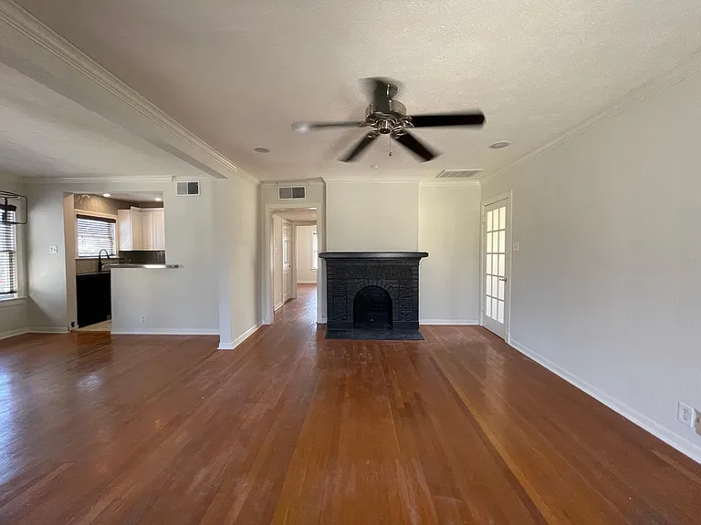 Livingroom with Entry on the Right Dinning and Kitchen on the left - Hardwood floor has just been refinished and stained a medium brown