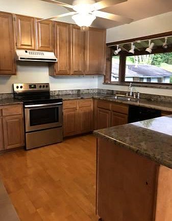 Kitchen with hardwood floors and marble countertops