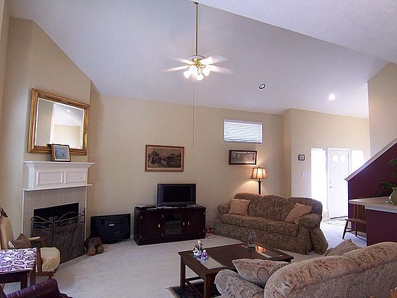 Corner fireplace with wood mantle and tile surround.