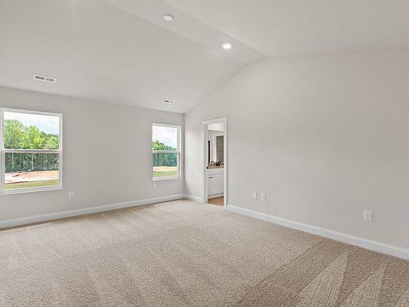 The master bedroom with a vaulted ceiling