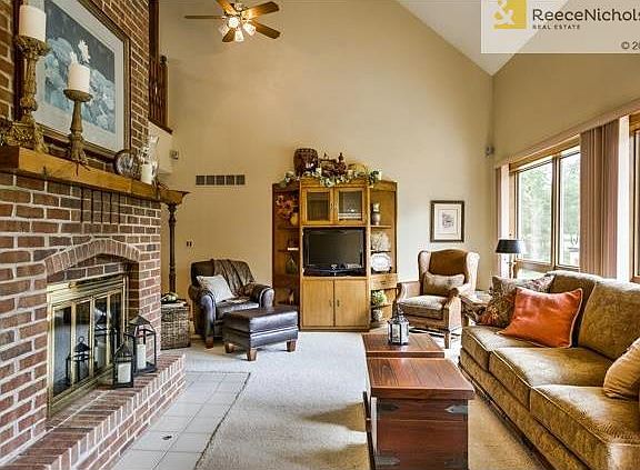 Two story Great Room with vaulted ceilings, fireplace & floor to ceiling windows