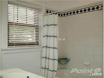 Jack & Jill bath with fresh white tile and navy accent tiles.