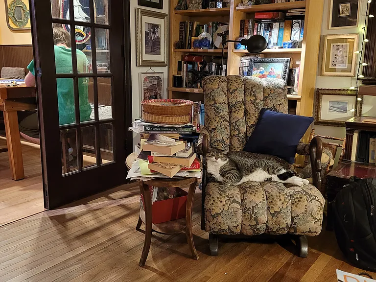House has living room and a den. This shows french doors from living into dining/kitchen.
