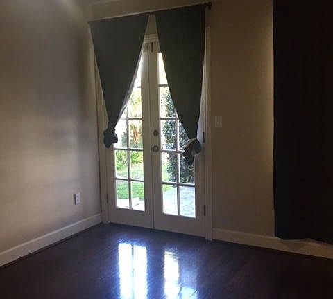 Downstairs bedroom with french doors to rear patio