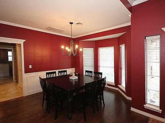 Formal Dining with Hardwood Flooring & Wainscoting