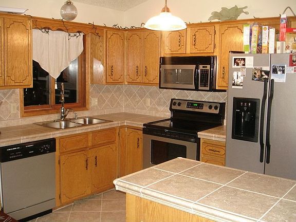 Kitchen with upgraded appliances and tile counters