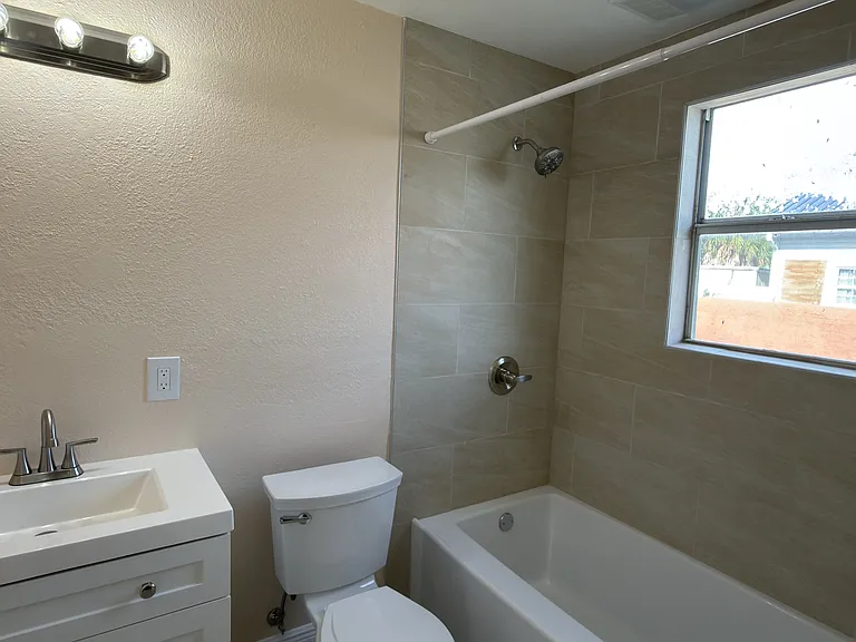 Updated Primary bathroom with neutral beige Ceramic Tile