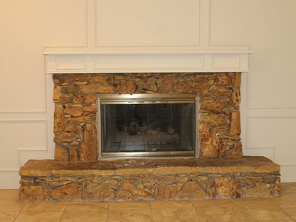 Fireplace with ceramic logs in Living Room