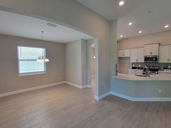 Sweetwater new home plan interior dining room to kitchen view at Tea Olive Terrace by William Ryan H