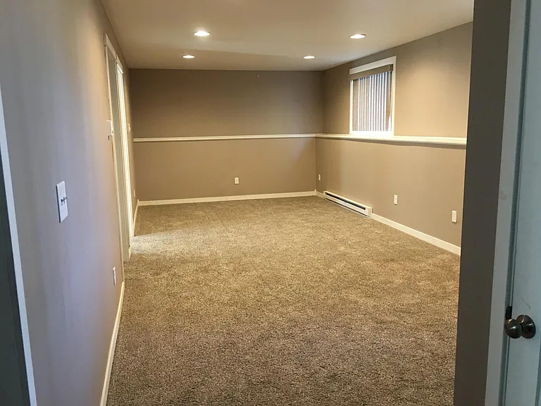 Downstairs living area. Awesome wrap-around shelf/ledge for speakers, pictures!