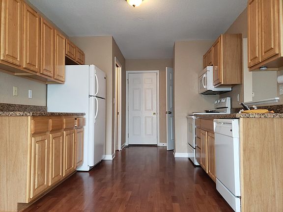 Kitchen - 1/2 bath at end on left, center door access to garage, right door to basement